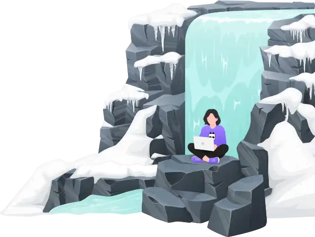 Engineer working on a laptop by a frozen waterfall surrounded by snow and ice. Illustrating a life-style built around remote work, digital nomads, and unique outdoor workspaces.